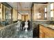 Striking bathroom features dark green marble walls and vanity top with gold hardware and decorative tile at 1777 Larimer St # 902, Denver, CO 80202