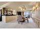 Bright dining room boasts chandelier, carpet, and glass table with seating for six, conveniently open to the kitchen at 1777 Larimer St # 902, Denver, CO 80202