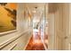 Hallway with wood flooring, decorative trim, and mirrored closet at 1777 Larimer St # 902, Denver, CO 80202