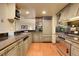 This kitchen features a wooden floor, marbled countertops, stainless steel appliances, and custom wood cabinets at 1777 Larimer St # 902, Denver, CO 80202