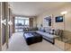 Inviting living room with a plush sofa, floor lamp, and access to the balcony at 1777 Larimer St # 902, Denver, CO 80202