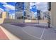 Rooftop sport court with a basketball hoop and net, offering recreational opportunities with stunning city views at 1777 Larimer St # 902, Denver, CO 80202