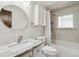 Updated bathroom with a tub, marble vanity, and white cabinets at 11921 W 70Th Pl, Arvada, CO 80004