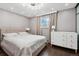 Main bedroom with a king bed, large dresser, and lots of natural light at 11921 W 70Th Pl, Arvada, CO 80004
