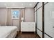 Main bedroom with a king bed, dresser, and sliding door to closet at 11921 W 70Th Pl, Arvada, CO 80004