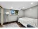 Finished basement bedroom with hardwood floors, a full-size bed, and a large window at 11921 W 70Th Pl, Arvada, CO 80004