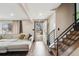 Spacious entryway with hardwood floors, modern staircase, and view to the front yard at 11921 W 70Th Pl, Arvada, CO 80004
