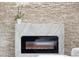 Modern electric fireplace with stone and marble surround at 11921 W 70Th Pl, Arvada, CO 80004