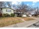 Ranch style home with attached garage and mature landscaping at 11921 W 70Th Pl, Arvada, CO 80004