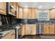 Kitchen with stainless steel appliances and wood cabinets at 11921 W 70Th Pl, Arvada, CO 80004