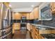 Updated kitchen with stainless steel appliances and wood cabinets at 11921 W 70Th Pl, Arvada, CO 80004