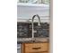 Modern kitchen sink and faucet with mosaic backsplash at 11921 W 70Th Pl, Arvada, CO 80004