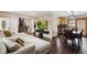 Open floor plan with living and dining areas and hardwood floors at 11921 W 70Th Pl, Arvada, CO 80004