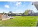 Sprawling backyard with lush grass, basketball court, shed, garden decor, and privacy fence at 10405 W 107Th Pl, Broomfield, CO 80021