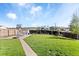 Spacious backyard featuring lush green grass, a basketball court, and plenty of room for outdoor activities at 10405 W 107Th Pl, Broomfield, CO 80021