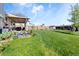 Extensive backyard featuring a patio, a playful rock pond, beautiful lawn, and a basketball court at 10405 W 107Th Pl, Broomfield, CO 80021