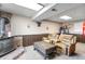 Basement featuring a brick fireplace, wood paneling, comfortable seating, and workout equipment at 10405 W 107Th Pl, Broomfield, CO 80021