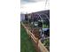 Home garden featuring raised beds, hanging baskets, and decorative garden art for a beautiful backyard space at 10405 W 107Th Pl, Broomfield, CO 80021