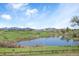 Picturesque golf course with a pond and mountain views, offering a serene and scenic recreational experience at 10405 W 107Th Pl, Broomfield, CO 80021