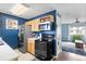 Kitchen features stainless steel appliances, dark backsplash, and seamless flow to the living area at 10405 W 107Th Pl, Broomfield, CO 80021