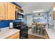 Kitchen showcasing stainless appliances, eat-in bar, and seamless flow to an adjacent dining area with bar at 10405 W 107Th Pl, Broomfield, CO 80021