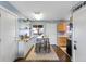 Kitchen showcases stainless appliances, eat-in bar, and seamless flow to an adjacent dining area with bar at 10405 W 107Th Pl, Broomfield, CO 80021