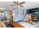 Open-concept living area featuring a TV, stairs, modern lighting, and seamless flow to the kitchen at 10405 W 107Th Pl, Broomfield, CO 80021
