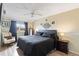 Comfortable main bedroom boasts a ceiling fan, large window, and neutral decor at 10405 W 107Th Pl, Broomfield, CO 80021