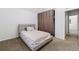 Bedroom featuring neutral carpeting, lots of closet space and soft grey accents at 1258 S Flower Cir # A, Lakewood, CO 80232