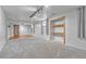 Finished basement area with new carpet, an egress window, and a separate closet with shelves at 3463 W Bowles Ave, Littleton, CO 80123