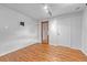 Cozy basement area with wood-look floors, wood trim, and a utility door at 3463 W Bowles Ave, Littleton, CO 80123