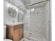 Modern bathroom featuring a tiled glass shower, updated lighting and vanity at 3463 W Bowles Ave, Littleton, CO 80123