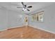 Light-filled bedroom with hardwood floors, ceiling fan, and views of the backyard at 3463 W Bowles Ave, Littleton, CO 80123