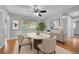 Bright dining room featuring wood floors, a modern ceiling fan, and a stylish table at 3463 W Bowles Ave, Littleton, CO 80123