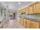 Bright kitchen with wooden cabinets, stone countertops and a sliding glass door to the backyard at 3463 W Bowles Ave, Littleton, CO 80123