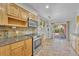 Cozy kitchen featuring wood cabinets, stone countertops and tile flooring with sliding glass doors at 3463 W Bowles Ave, Littleton, CO 80123