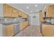 Well-lit kitchen featuring wood cabinets, stainless steel appliances and light tile flooring at 3463 W Bowles Ave, Littleton, CO 80123