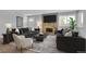 Inviting living room featuring a stone fireplace, comfortable seating, and lots of natural light at 3463 W Bowles Ave, Littleton, CO 80123