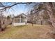 Spacious backyard featuring a sunroom, patio area, and a mix of grass and landscaping at 10450 W 81St Pl, Arvada, CO 80005