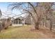 Large backyard featuring lawn, screened in porch, trees and wood fence at 10450 W 81St Pl, Arvada, CO 80005