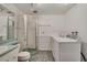 Bathroom featuring a shower, toilet, laundry machines, sink and mirror at 10450 W 81St Pl, Arvada, CO 80005