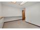 Bedroom featuring neutral carpet, white walls, and view into an adjoining room at 10450 W 81St Pl, Arvada, CO 80005