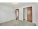 Clean bedroom with neutral carpet, natural light, and closet at 10450 W 81St Pl, Arvada, CO 80005