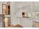 Bright entryway featuring a staircase, white walls, and an open view into the kitchen and sunroom at 10450 W 81St Pl, Arvada, CO 80005