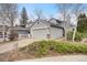 Charming home with gray siding, a two-car garage, and well-maintained landscaping at 10450 W 81St Pl, Arvada, CO 80005