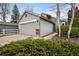 Charming home featuring a grey exterior, well-maintained landscaping, and an attached two-car garage at 10450 W 81St Pl, Arvada, CO 80005