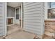 Enclosed front porch with brick accents and painted siding at 10450 W 81St Pl, Arvada, CO 80005