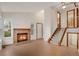 Inviting living room showcasing a cozy fireplace, neutral walls, and staircase to the upper level at 10450 W 81St Pl, Arvada, CO 80005