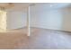 Unfinished basement featuring neutral carpet, a support column, and white painted walls at 6885 Saddleback Ave, Firestone, CO 80504