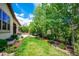 Lush backyard featuring a well-manicured lawn and mature trees offering shade at 2264 S Joyce St, Lakewood, CO 80228